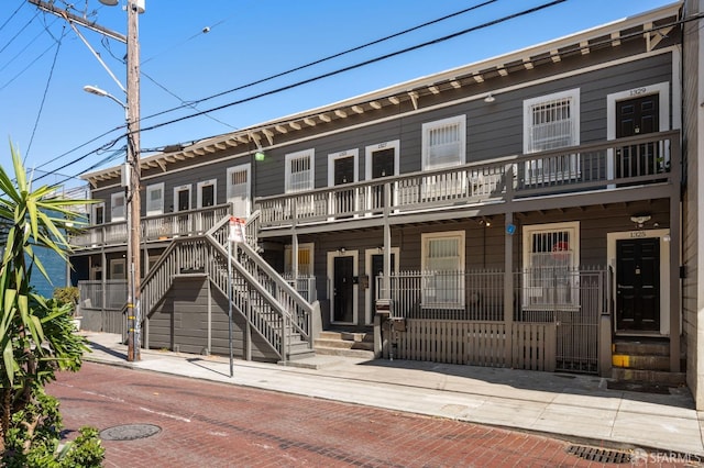 view of front of property featuring a balcony and a porch