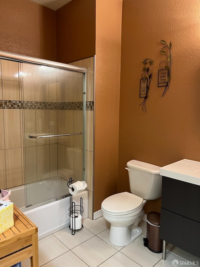 full bathroom featuring vanity, shower / bath combination with glass door, tile patterned floors, and toilet