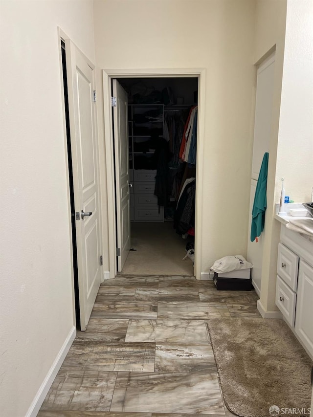 corridor with light hardwood / wood-style floors