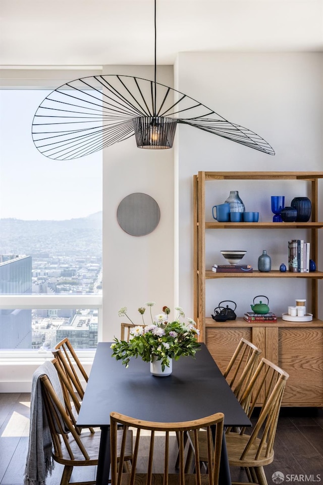 dining area featuring an inviting chandelier and dark wood-type flooring