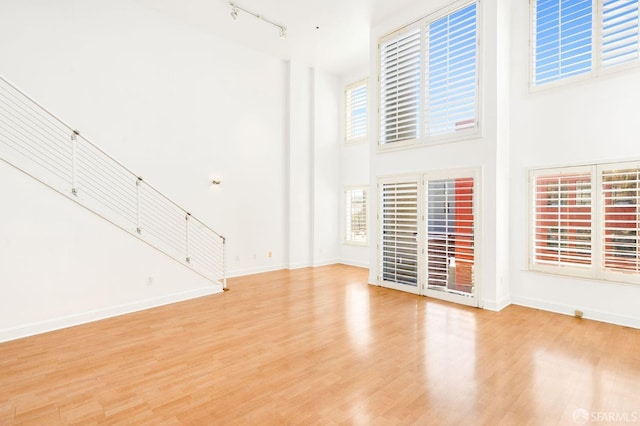 unfurnished living room with a healthy amount of sunlight and light wood-type flooring