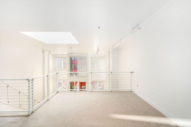 playroom with a skylight, ceiling fan, and carpet