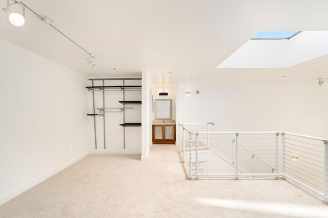 carpeted spare room with a skylight