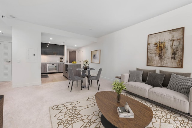 living area featuring recessed lighting, baseboards, and light carpet