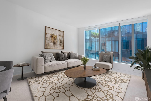 carpeted living room featuring baseboards
