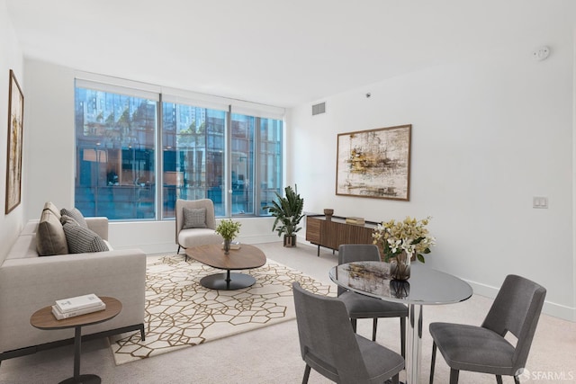 carpeted living area with visible vents and baseboards