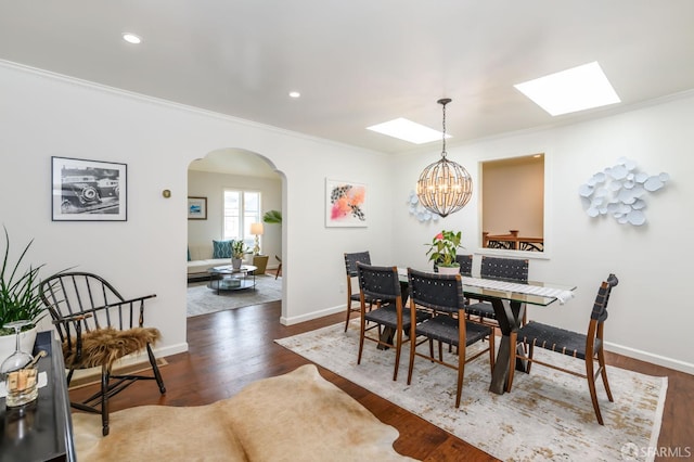117 Meadowbrook Dr, San Francisco, CA 94132 - dining area with a skylight, arched walkways, crown molding, wood finished floors, and a chandelier