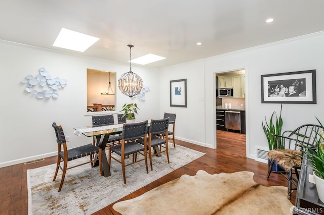 117 Meadowbrook Dr, San Francisco, CA 94132 - dining room featuring a skylight, a chandelier, ornamental molding, dark wood finished floors, and recessed lighting