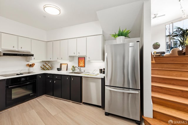 1603 18th St, San Francisco, CA 94107 - kitchen featuring black appliances, under cabinet range hood, white cabinets, and dark cabinets