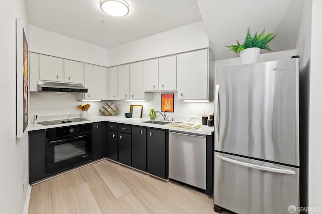 1603 18th St, San Francisco, CA 94107 - kitchen with black appliances, under cabinet range hood, white cabinets, and light countertops