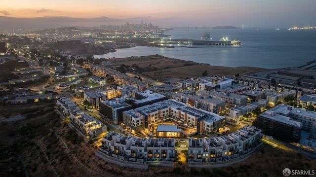 aerial view at dusk with a water view and a city view