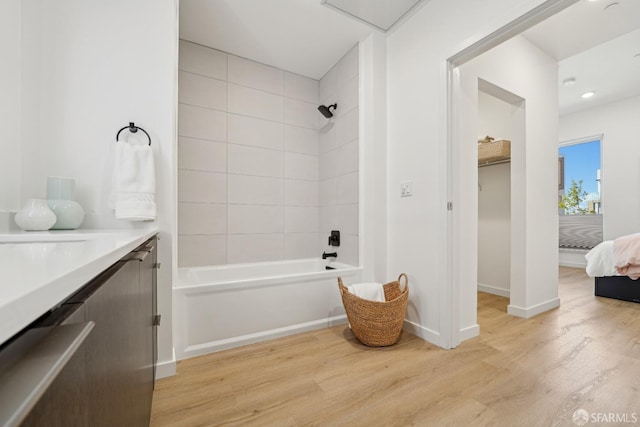 full bathroom featuring vanity, shower / bathing tub combination, wood finished floors, ensuite bathroom, and baseboards