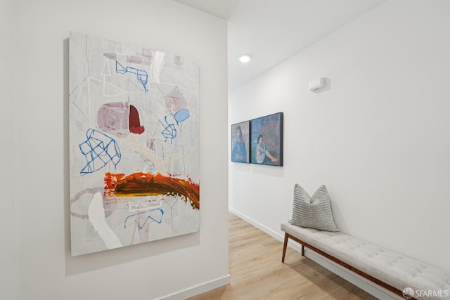 hallway featuring baseboards and wood finished floors