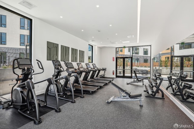 workout area featuring recessed lighting, baseboards, a wall of windows, and visible vents