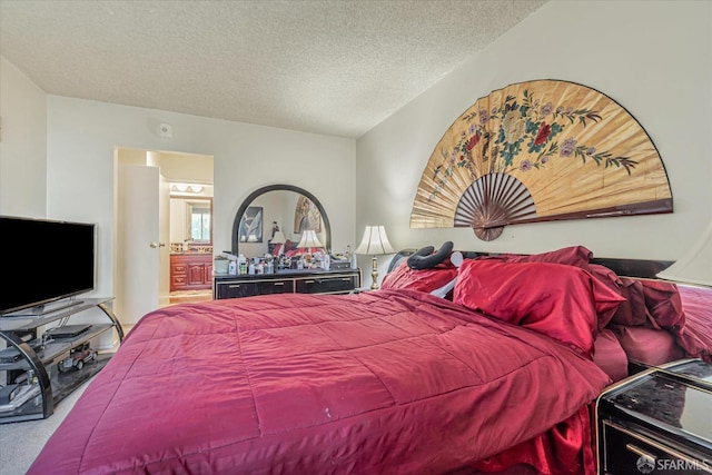 carpeted bedroom featuring a textured ceiling