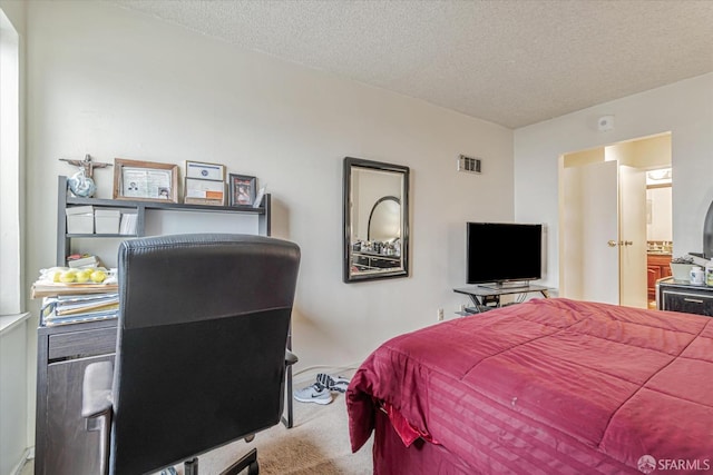 bedroom featuring carpet and a textured ceiling