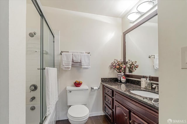 full bathroom featuring vanity, combined bath / shower with glass door, and toilet