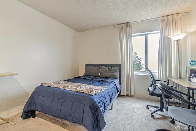 bedroom with light carpet and a textured ceiling