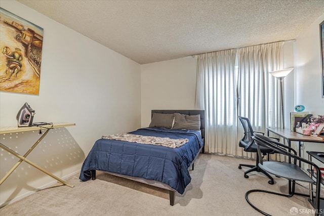 carpeted bedroom with a textured ceiling