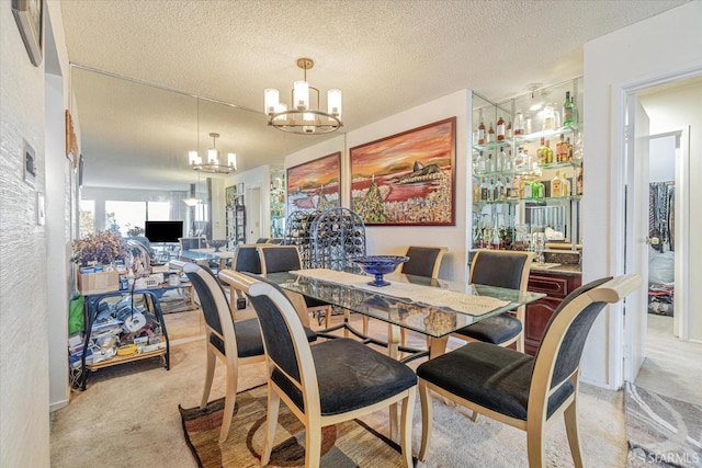 dining area with a notable chandelier, light colored carpet, and a textured ceiling