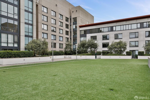 view of property's community with a lawn