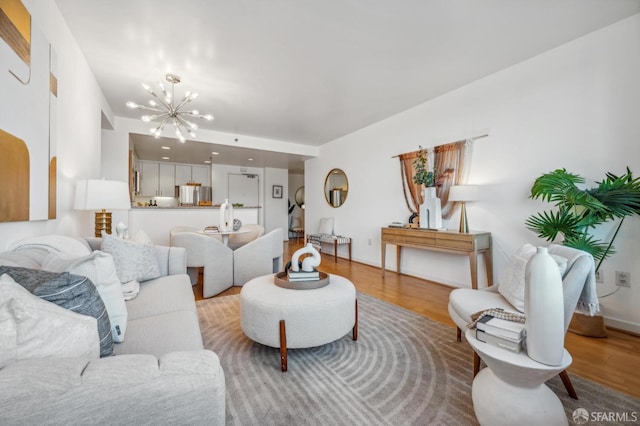 living room with an inviting chandelier and wood-type flooring