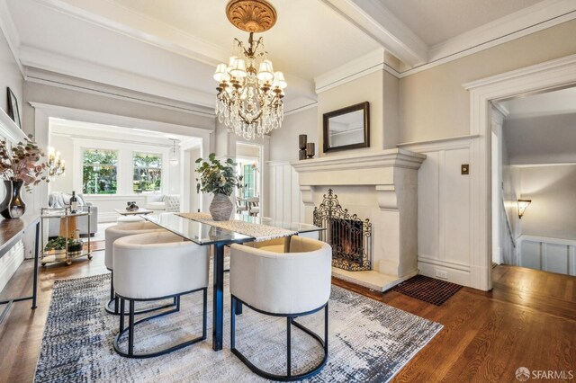 68 Castro St, San Francisco, CA 94114 - dining space featuring a decorative wall, wood finished floors, a chandelier, crown molding, and a fireplace with raised hearth