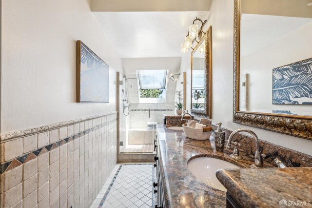 68 Castro St, San Francisco, CA 94114 - full bathroom with tile walls, tiled shower, double vanity, tile patterned floors, and a wainscoted wall