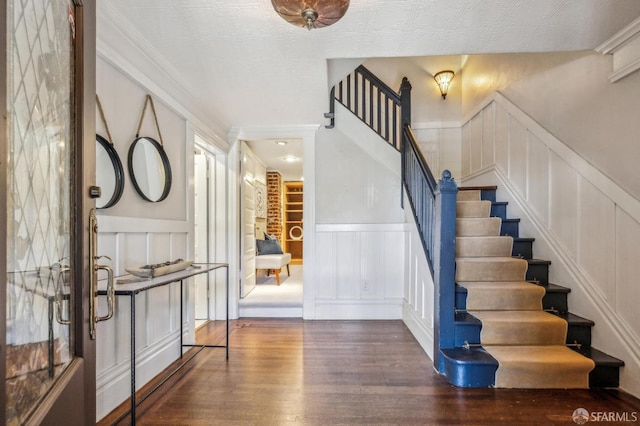 68 Castro St, San Francisco, CA 94114 - entryway featuring a decorative wall, wood finished floors, stairs, wainscoting, and crown molding