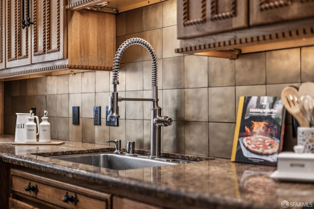 68 Castro St, San Francisco, CA 94114 - kitchen with a sink, backsplash, and dark stone countertops
