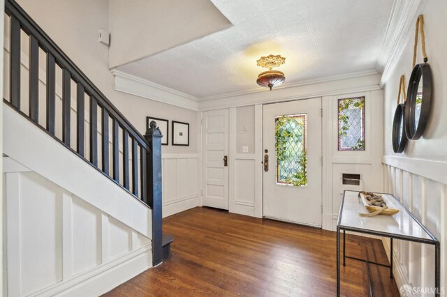 68 Castro St, San Francisco, CA 94114 - foyer featuring stairway, a decorative wall, wood finished floors, and ornamental molding