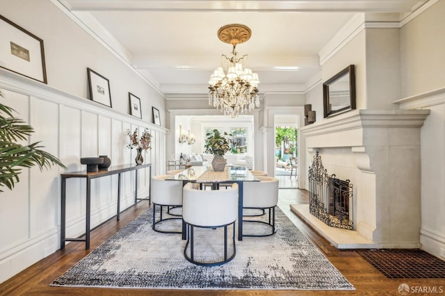 68 Castro St, San Francisco, CA 94114 - dining area with a chandelier, a decorative wall, dark wood-type flooring, a fireplace with raised hearth, and ornamental molding