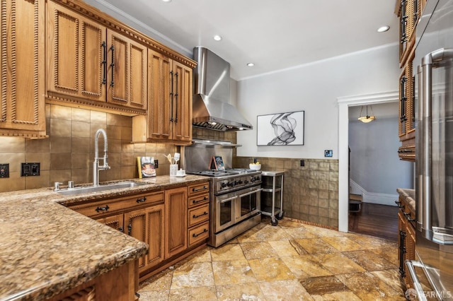 68 Castro St, San Francisco, CA 94114 - kitchen with wall chimney exhaust hood, a sink, double oven range, brown cabinets, and tile walls