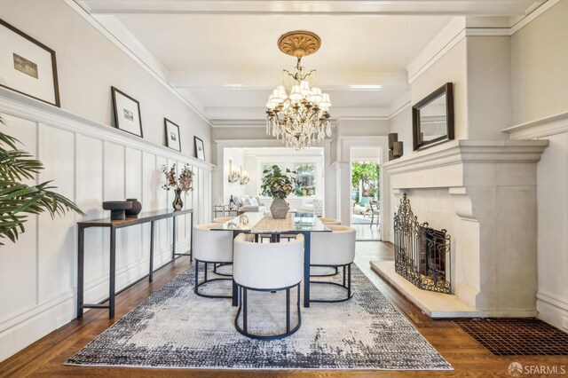 68 Castro St, San Francisco, CA 94114 - dining area with a chandelier, a decorative wall, dark wood-type flooring, a fireplace with raised hearth, and ornamental molding