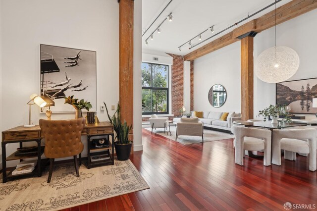 home office featuring decorative columns and hardwood / wood-style floors