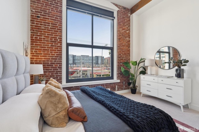 bedroom with light carpet, brick wall, and baseboards