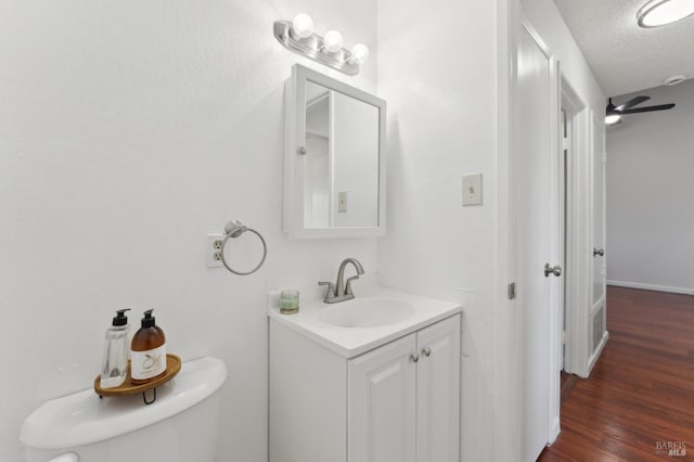 355 Parkview Ter Unit A6, Vallejo, CA 94589 - bathroom featuring a textured ceiling, wood finished floors, vanity, baseboards, and toilet