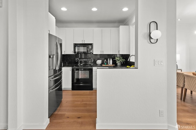 536 Wisconsin St, San Francisco, CA 94107 - kitchen featuring black appliances, dark countertops, white cabinetry, backsplash, and light wood-style floors