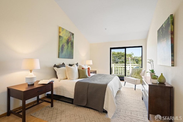 bedroom with lofted ceiling and wood finished floors
