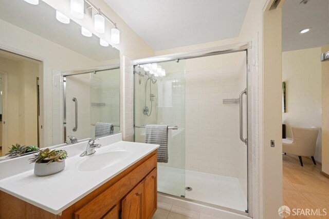full bath featuring vanity and a shower stall