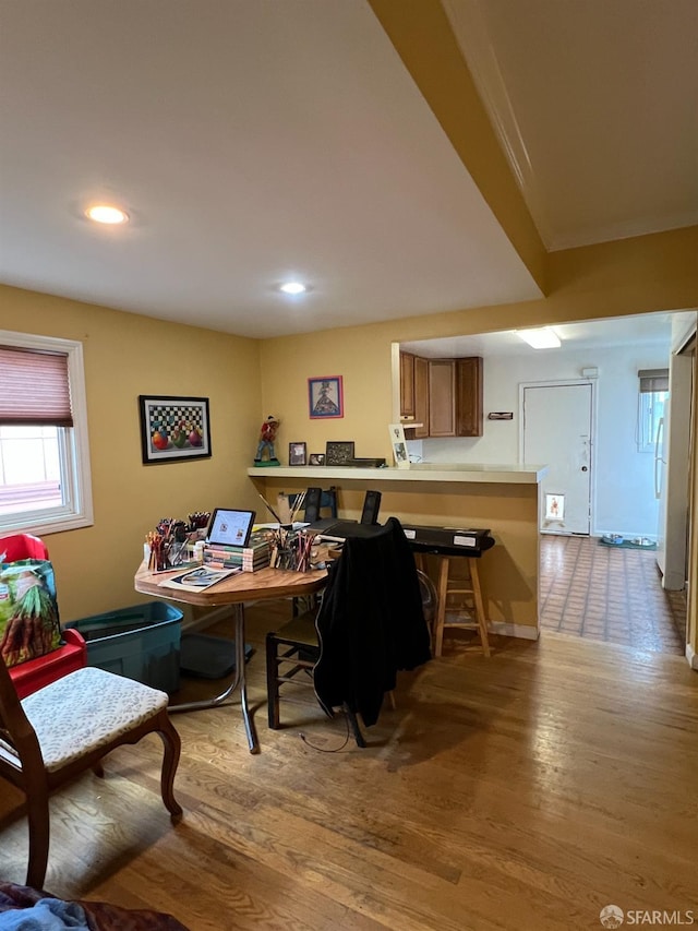 home office with light hardwood / wood-style flooring