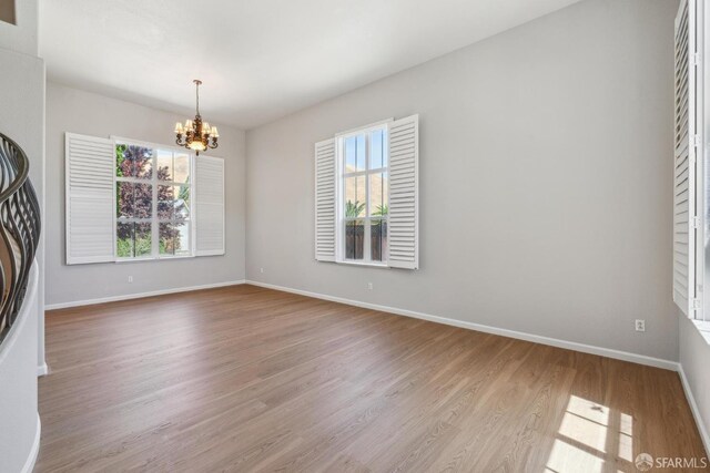 5317 Judsonville Dr, Antioch, CA 94531 - spare room with a chandelier, wood finished floors, and baseboards