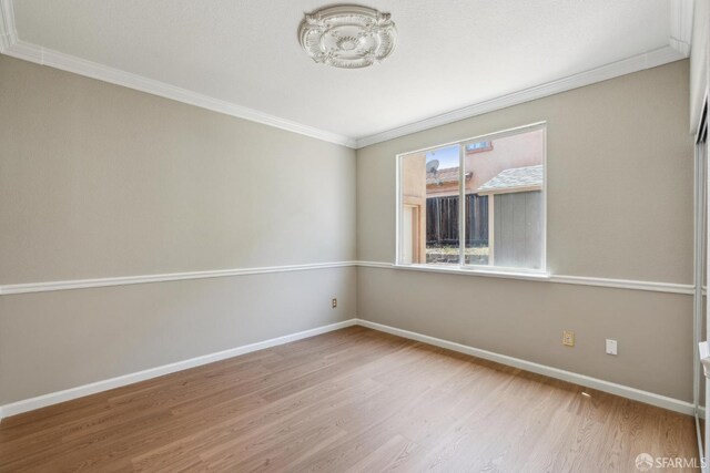 5317 Judsonville Dr, Antioch, CA 94531 - spare room with crown molding, a chandelier, wood finished floors, and baseboards