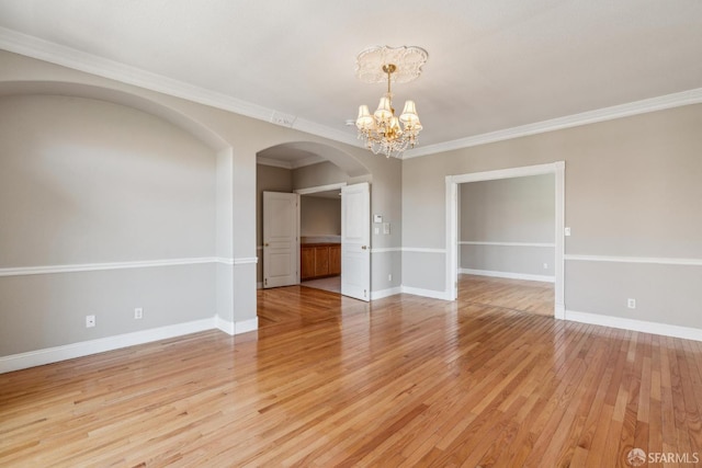 5317 Judsonville Dr, Antioch, CA 94531 - unfurnished room with a chandelier, crown molding, arched walkways, light wood-type flooring, and baseboards