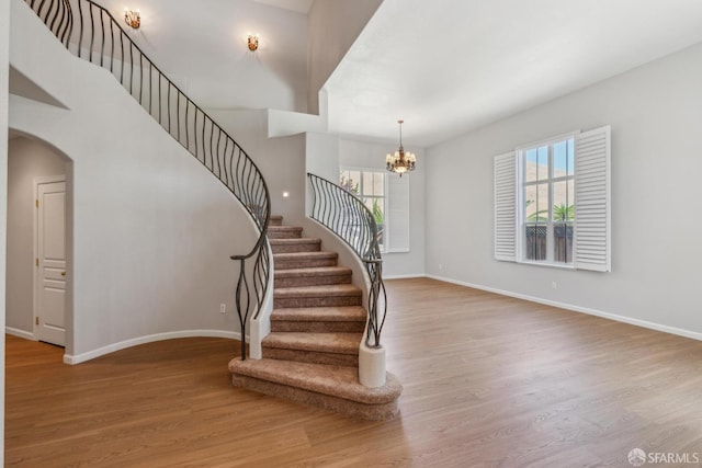5317 Judsonville Dr, Antioch, CA 94531 - stairway with wood finished floors, arched walkways, a chandelier, and baseboards