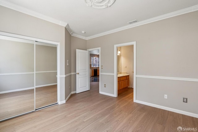 5317 Judsonville Dr, Antioch, CA 94531 - unfurnished bedroom featuring light wood-style flooring, crown molding, a closet, baseboards, and ensuite bath