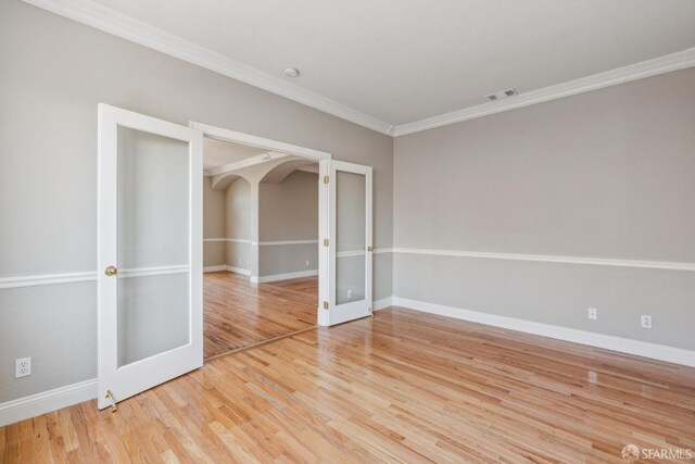 5317 Judsonville Dr, Antioch, CA 94531 - empty room with french doors, ornamental molding, baseboards, wood finished floors, and arched walkways