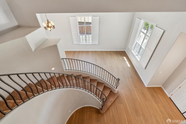 5317 Judsonville Dr, Antioch, CA 94531 - staircase with wood finished floors, plenty of natural light, a chandelier, and baseboards