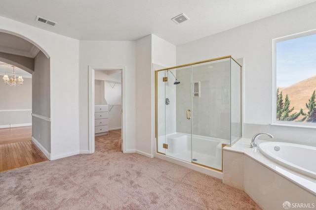 5317 Judsonville Dr, Antioch, CA 94531 - full bath featuring a stall shower, a bath, a chandelier, and carpet flooring