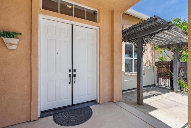 5317 Judsonville Dr, Antioch, CA 94531 - view of exterior entry with stucco siding, a pergola, and fence